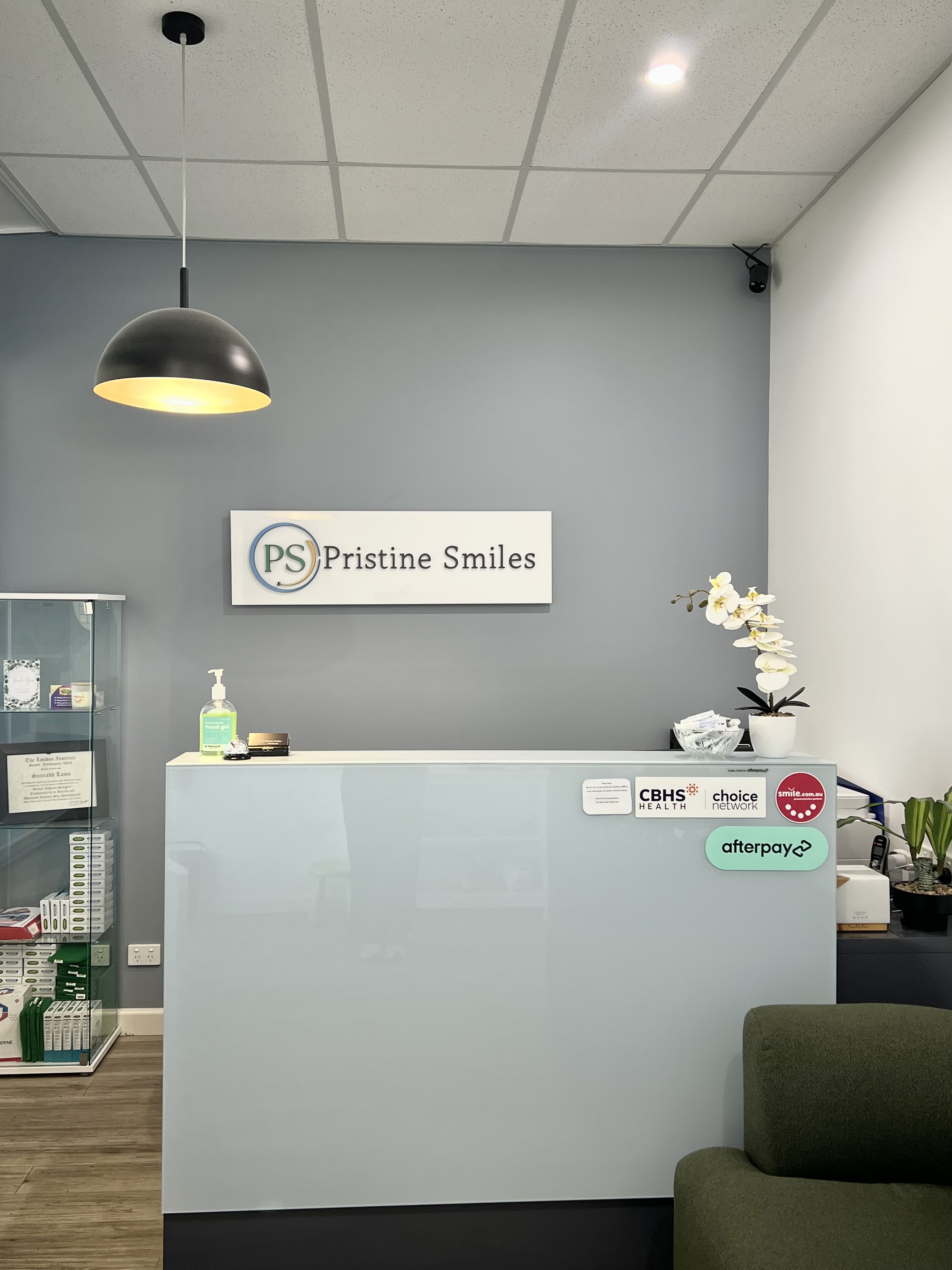The calm, light-filled reception area at Pristine Smiles